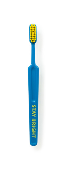 Navy toothbrush with yellow bristles and the saying 'Stay Bright' on the handle