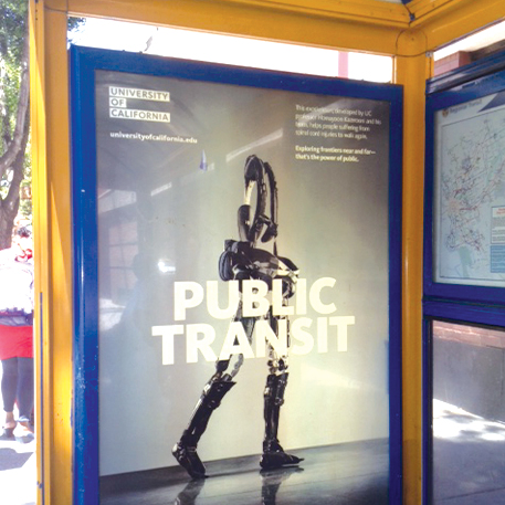 Poster inside bus shelter of a robotic exoskeleton and the words Public Transit